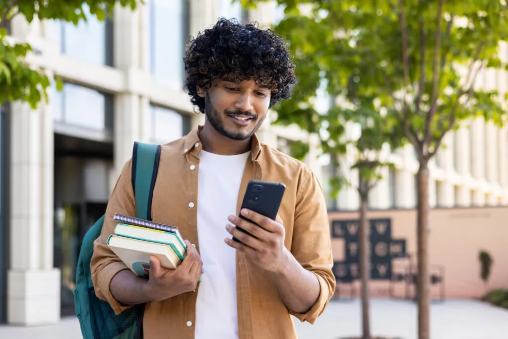 Student sending a Housr Bills referral code on their phone.